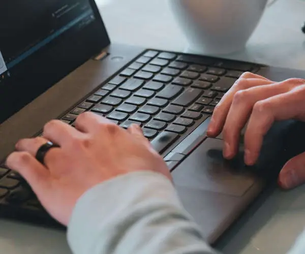 Hands on a laptop keyboard