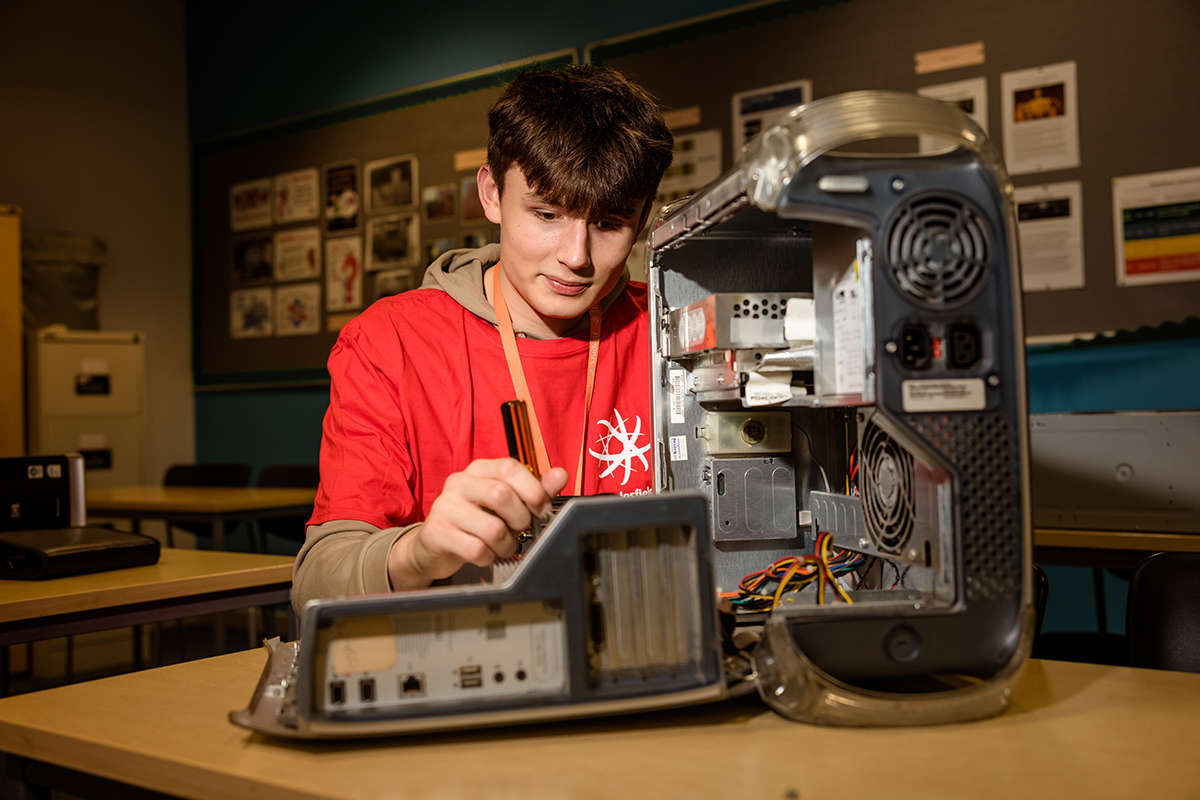 a student inspects an open computer