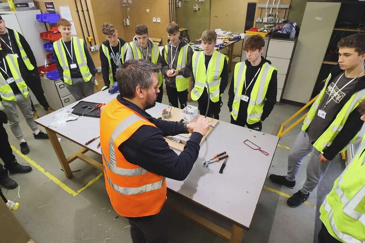 a construction tutor demonstrating to a group of students