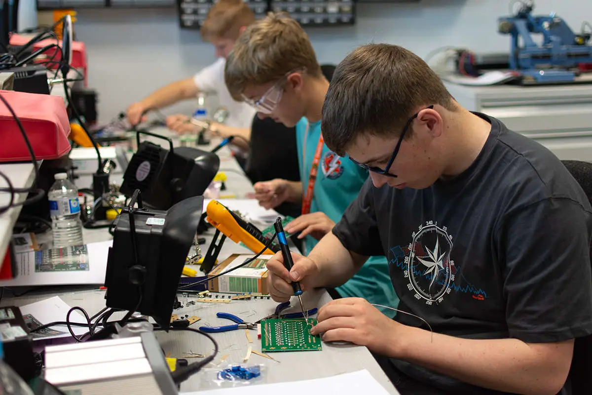 students soldering circuit boards