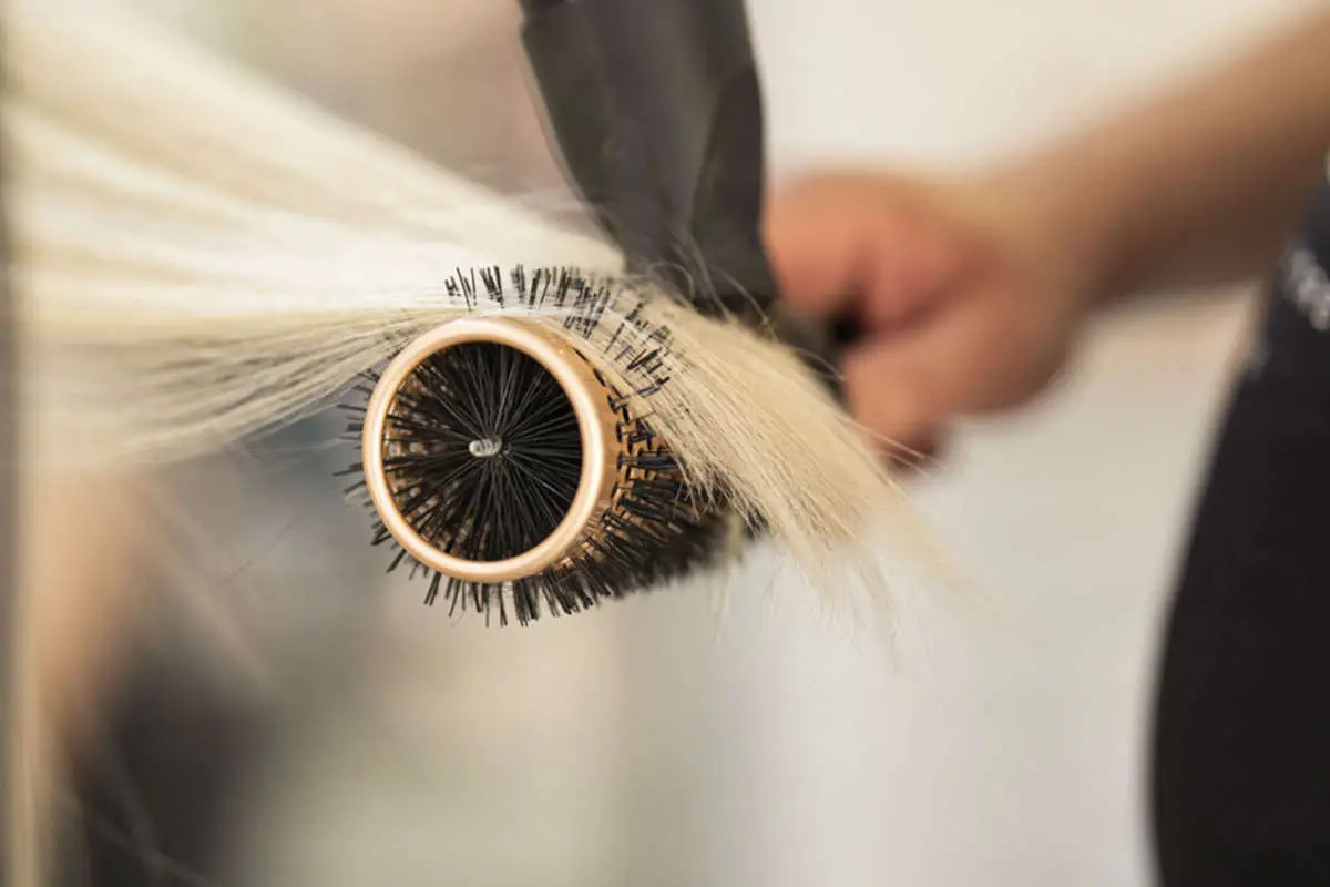 Blonde hair being brushed and blow dried