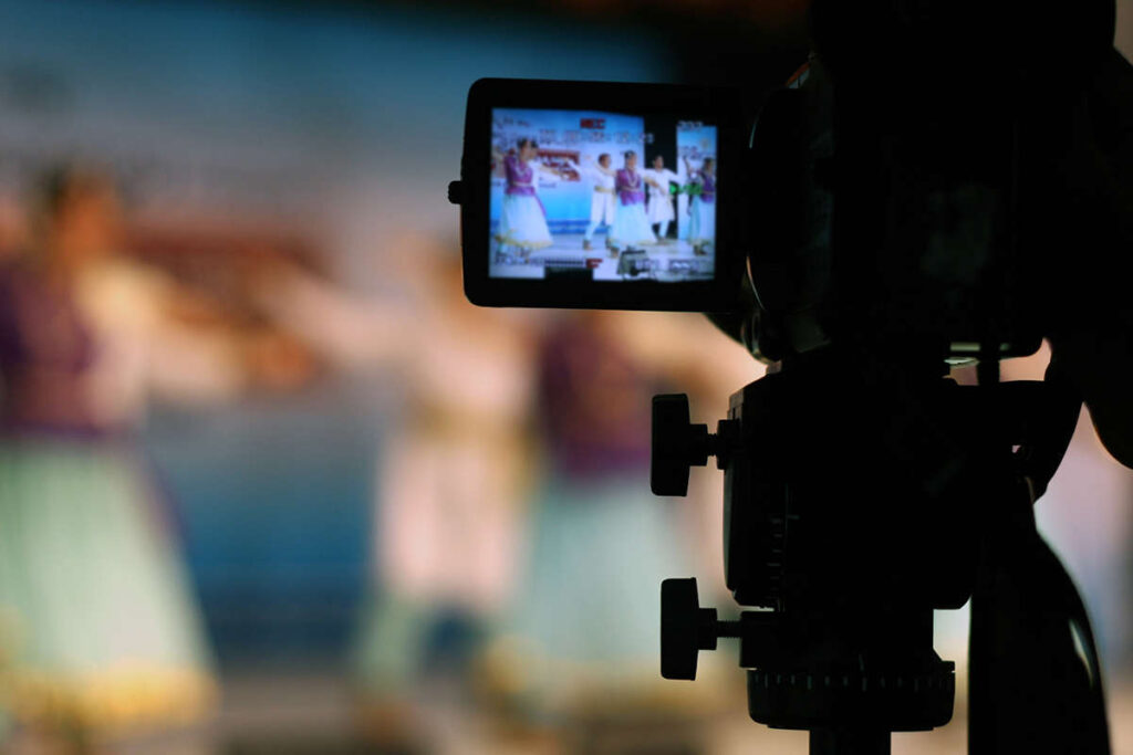 a view through a camera lens of some Bollywood style dancers