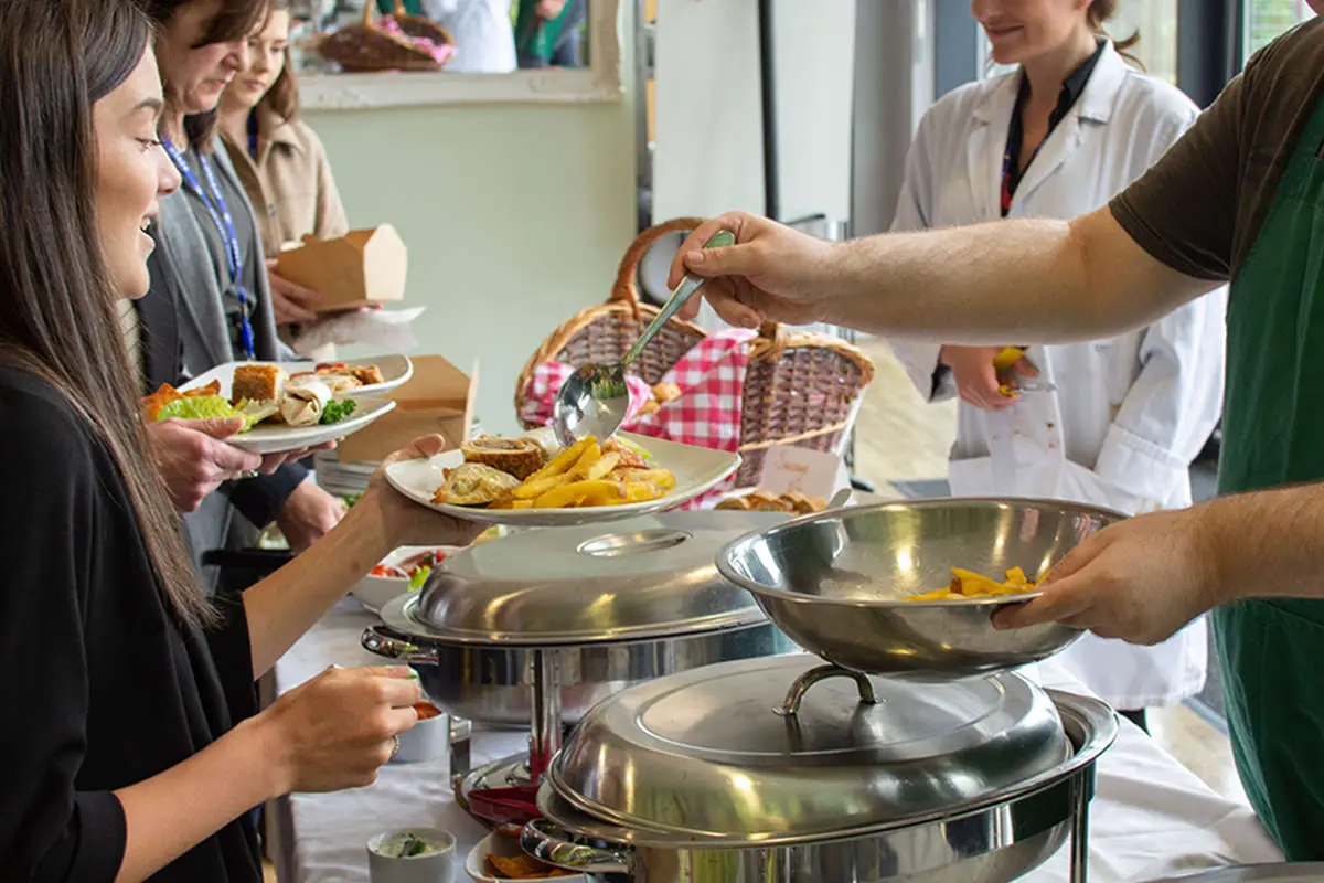 Food being served to a queue of people