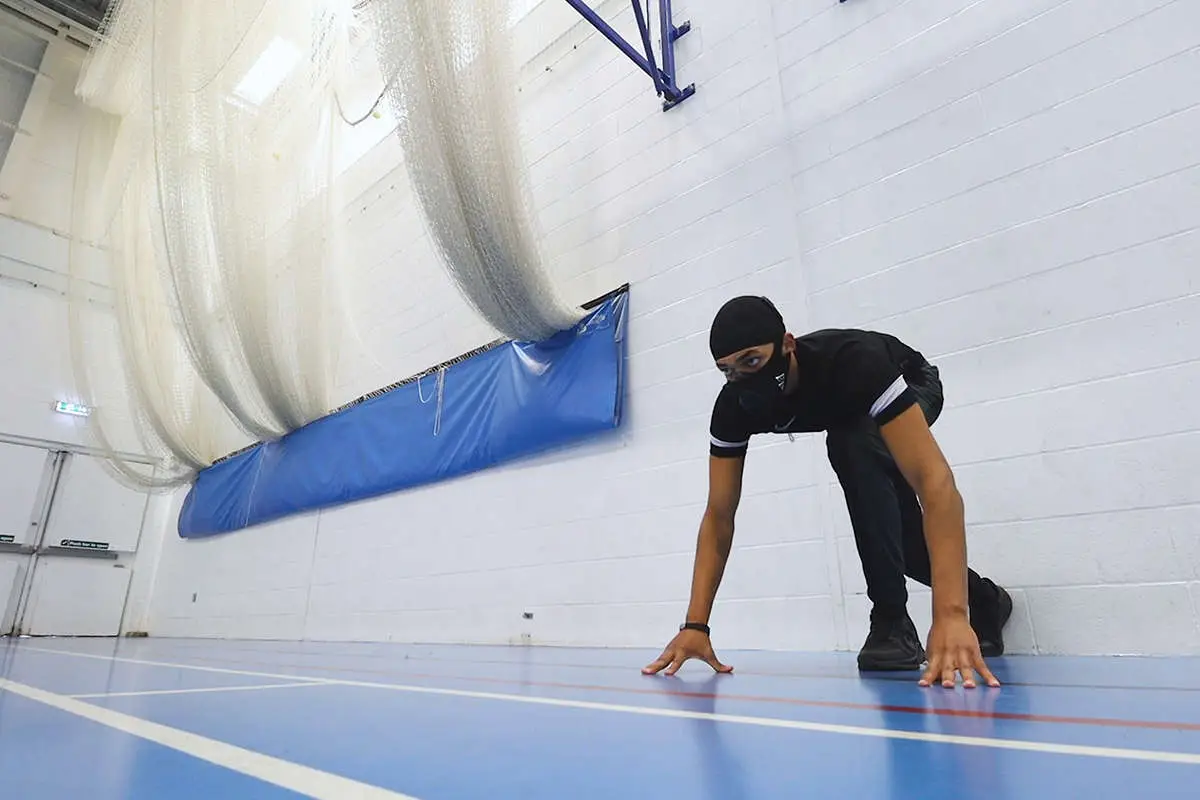 a male in a ready to sprint start position