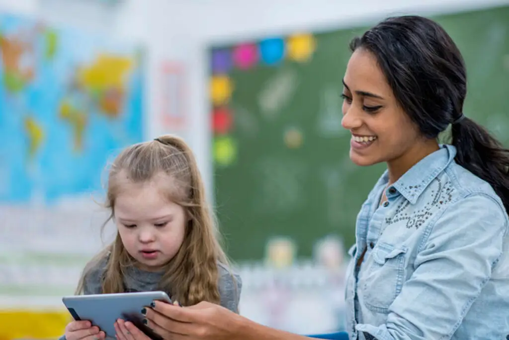 A young lady with a small child in a school envrioment teaching her