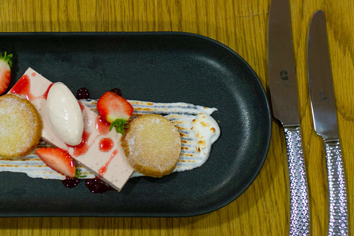 A plate if short bread biscuits, strawberries and ice cream
