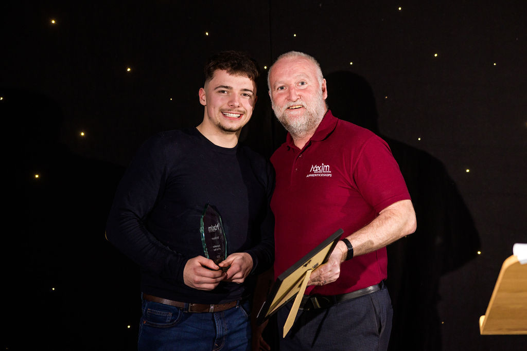 The bricklaying apprentice of the year being presented his award by his tutor, Tony Costello