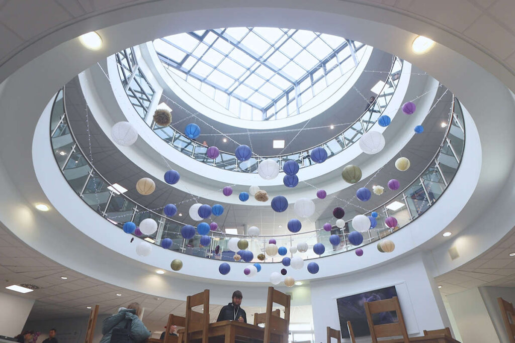 An artistic shot of macclesfield college ceiling in the foyer filled with balloons