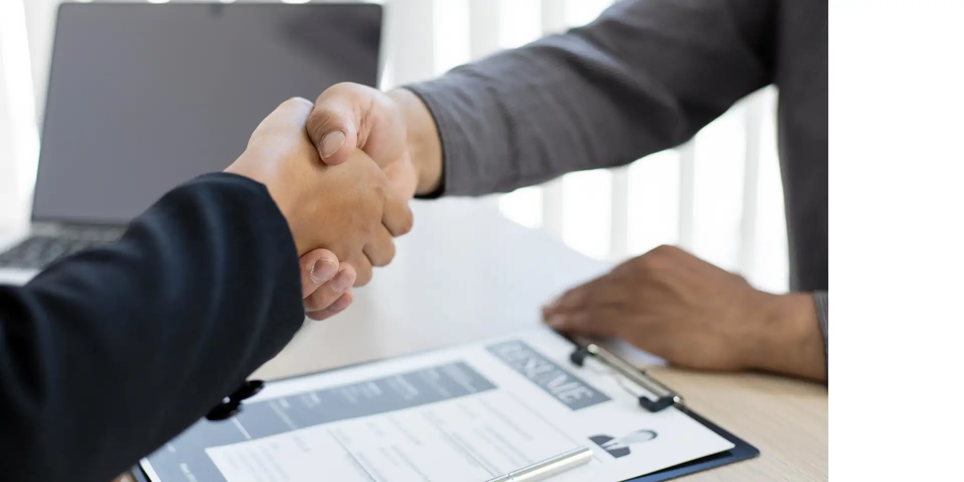 A business meeting with two people shaking hands