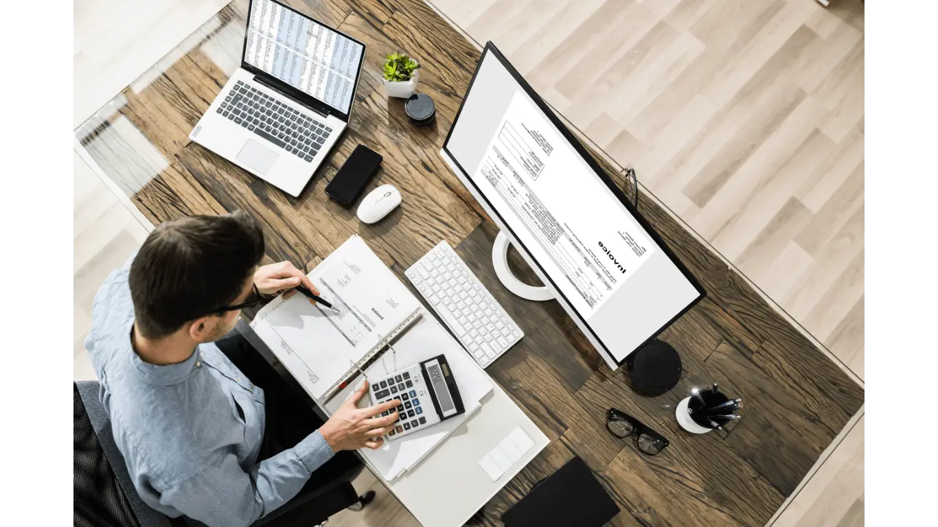 An accountant working at his desk with a calculator or computer