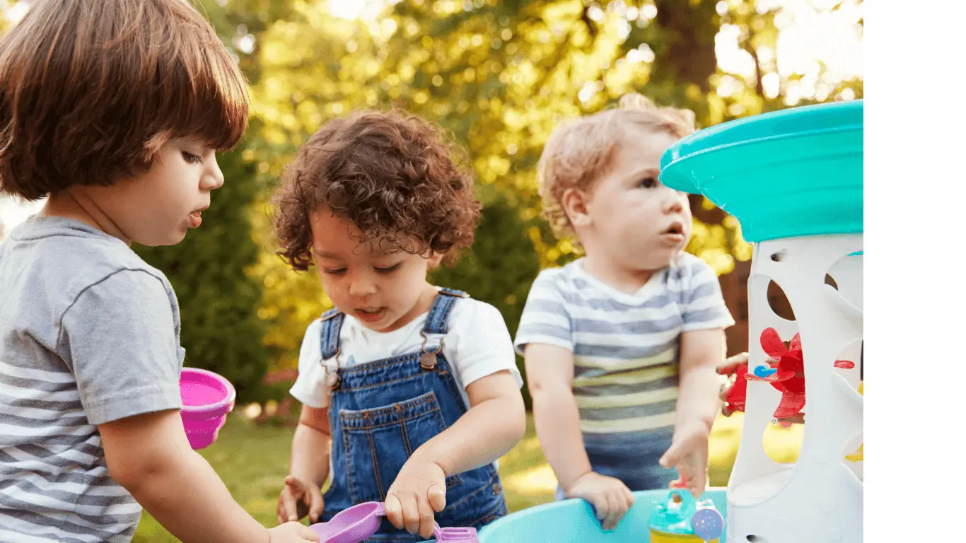 three young children playing in the garden