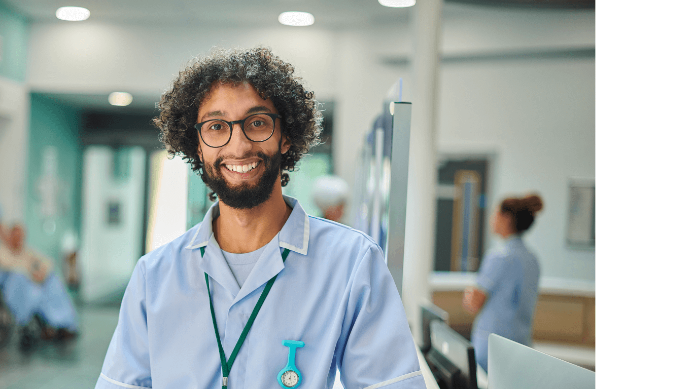 a male health care student smiling in a hospital
