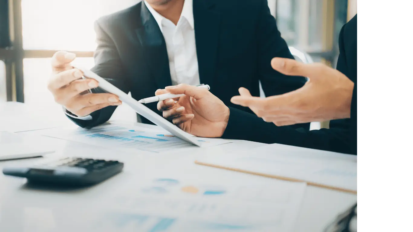 two finance apprentices discussing work