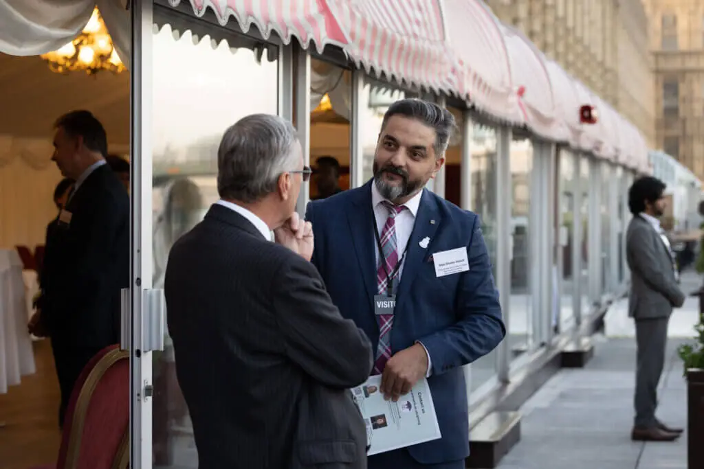 Two male men are talking during an event
