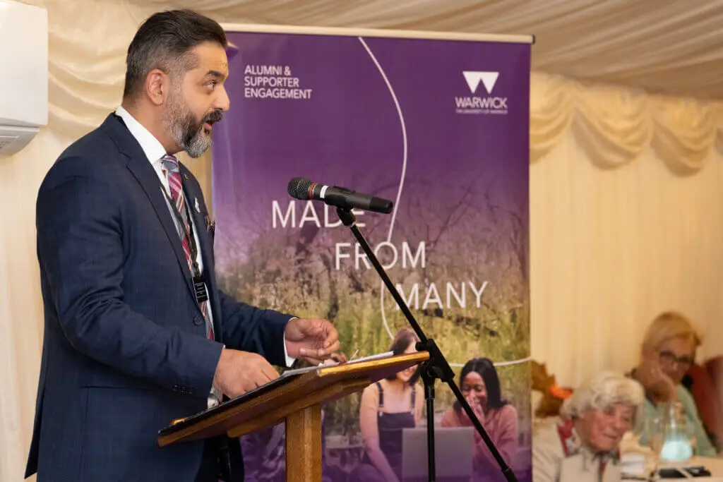 A male is talking on a podium during an event