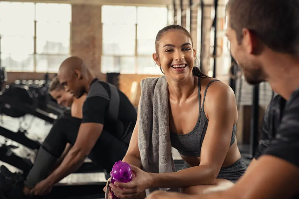 A group of people, dressed in gym clothes, are talking