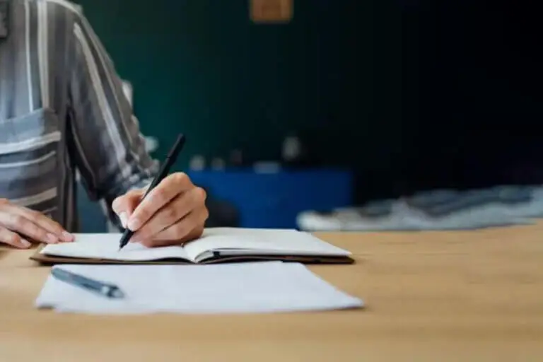 Someone writing in a notebook