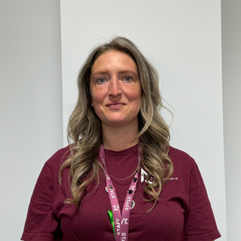 A headshot of a staff member smiling.