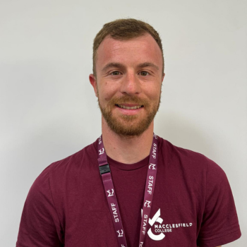 A headshot of a staff member smiling.