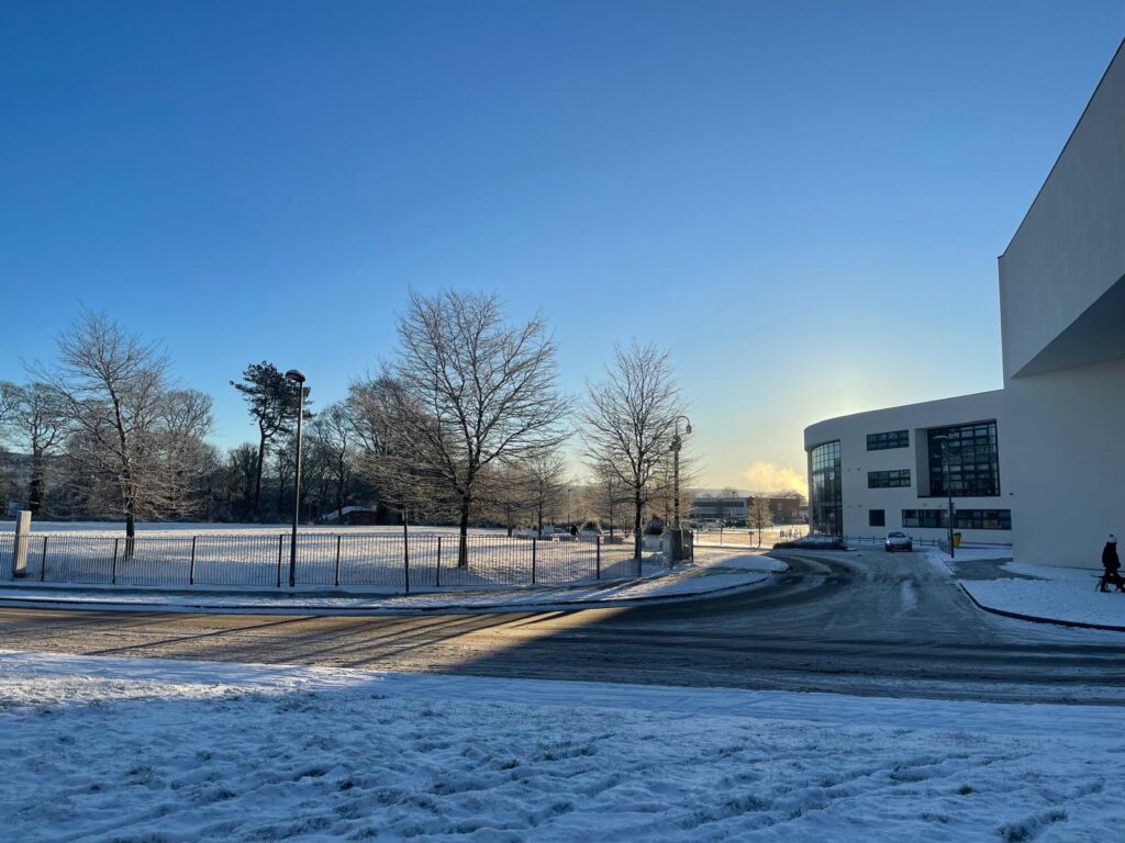 Macclesfield College field with a sunny snowy setting.