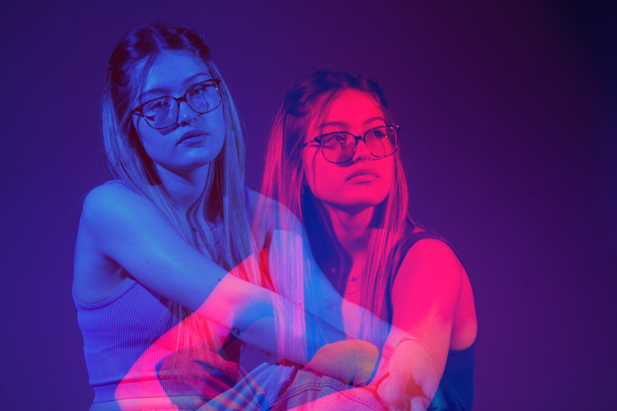 A vibrant photograph captured by one of our Art students features a seated model as the central focus. Beside them appears a translucent replica, echoing their form.