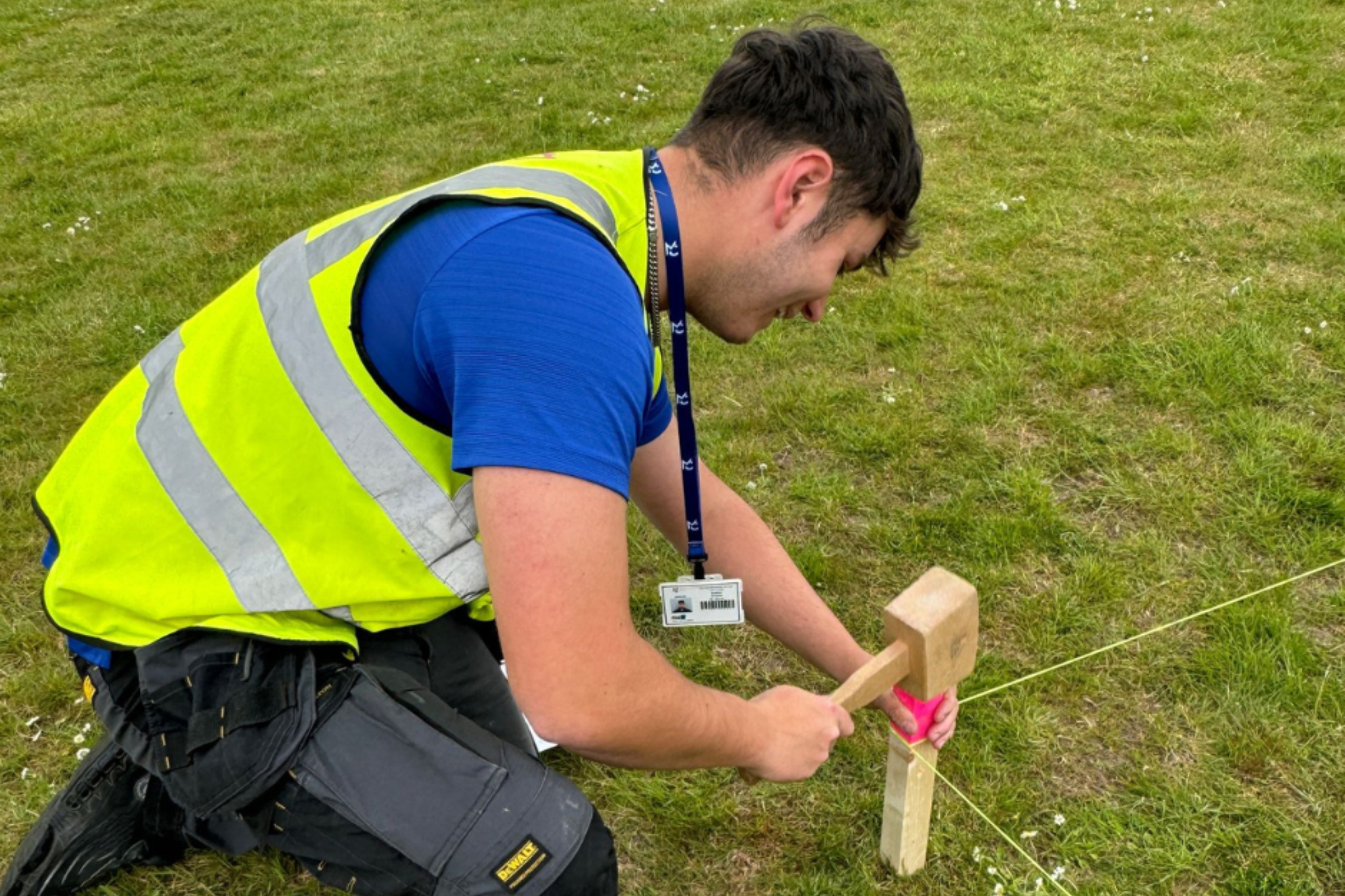 A Carpentry and Joinery apprentice is plotting groundwork dimensions from drawings.