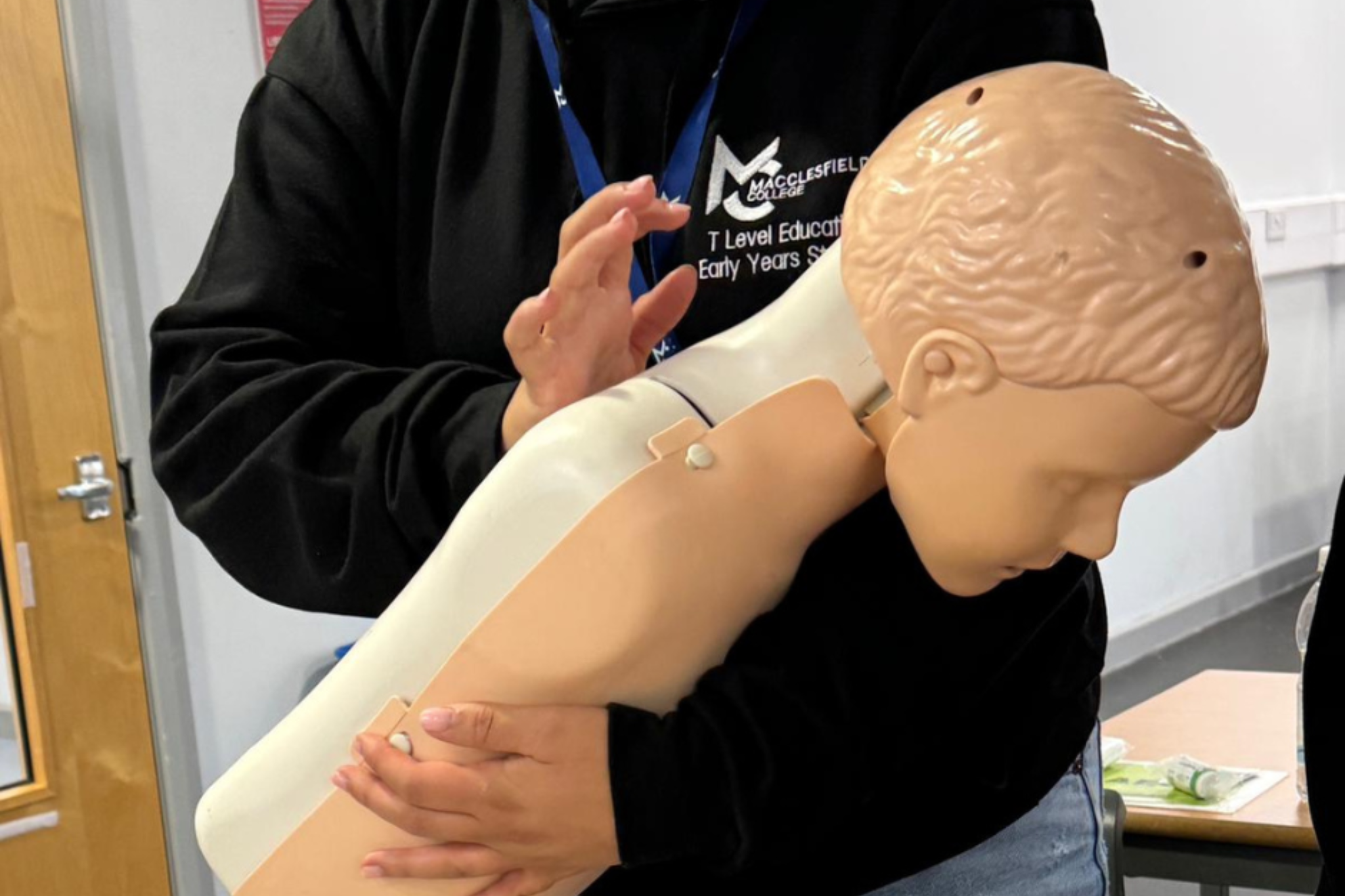 A Childcare student is practising CPR.