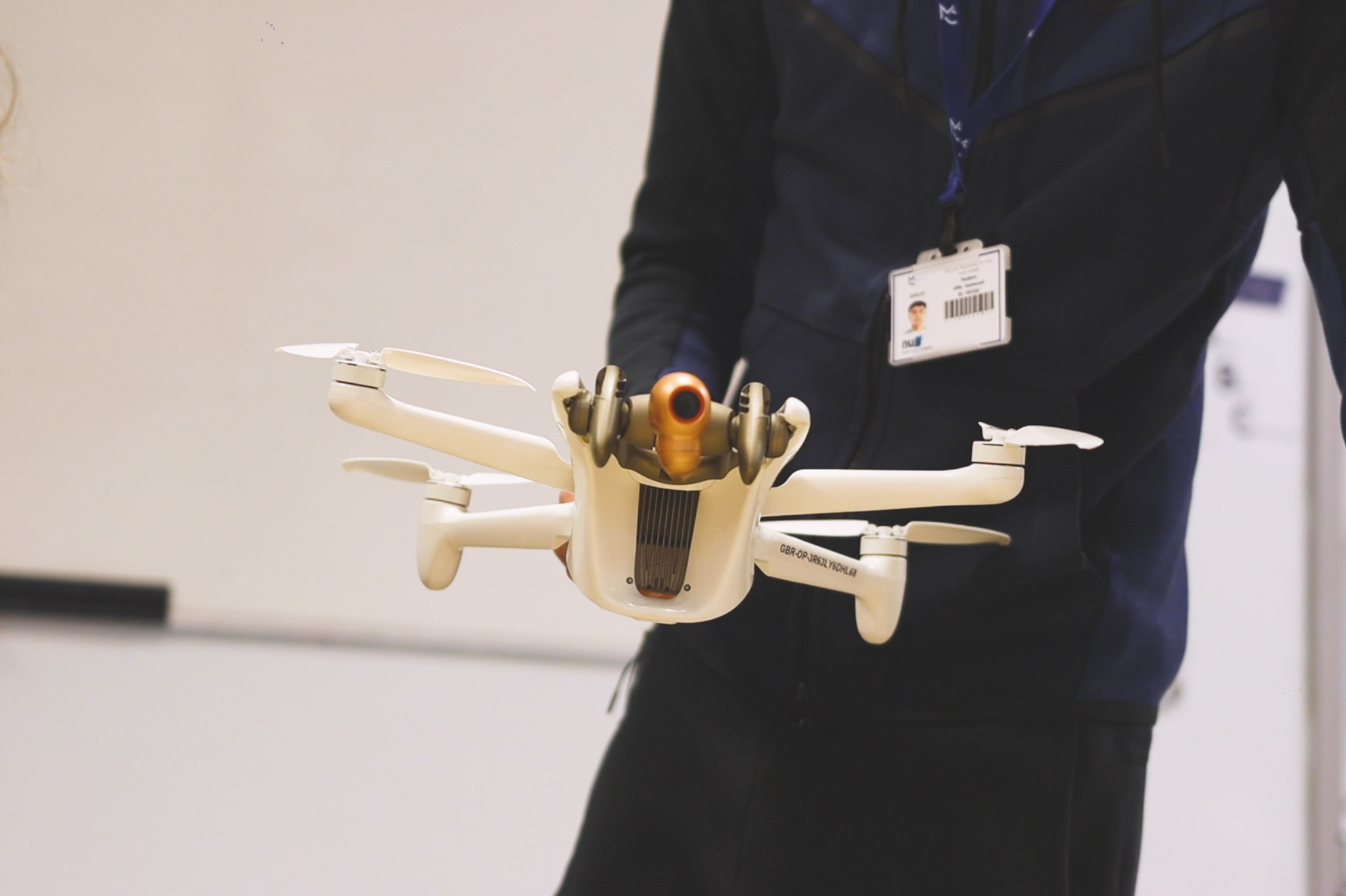 A student is holding a construction drone