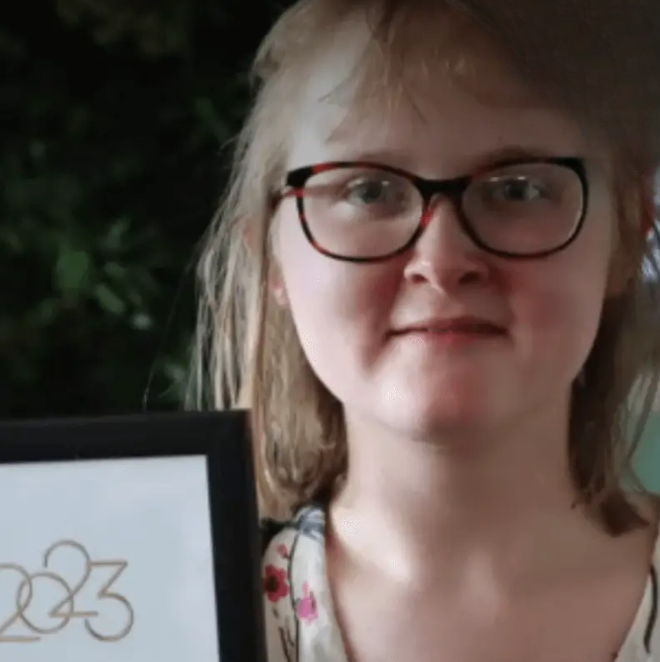 A student is smiling for a headshot photo