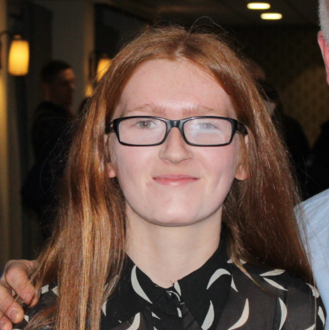 A student smiling for a headshot photo