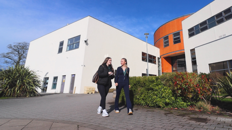 two female students walking outside macclesfield college