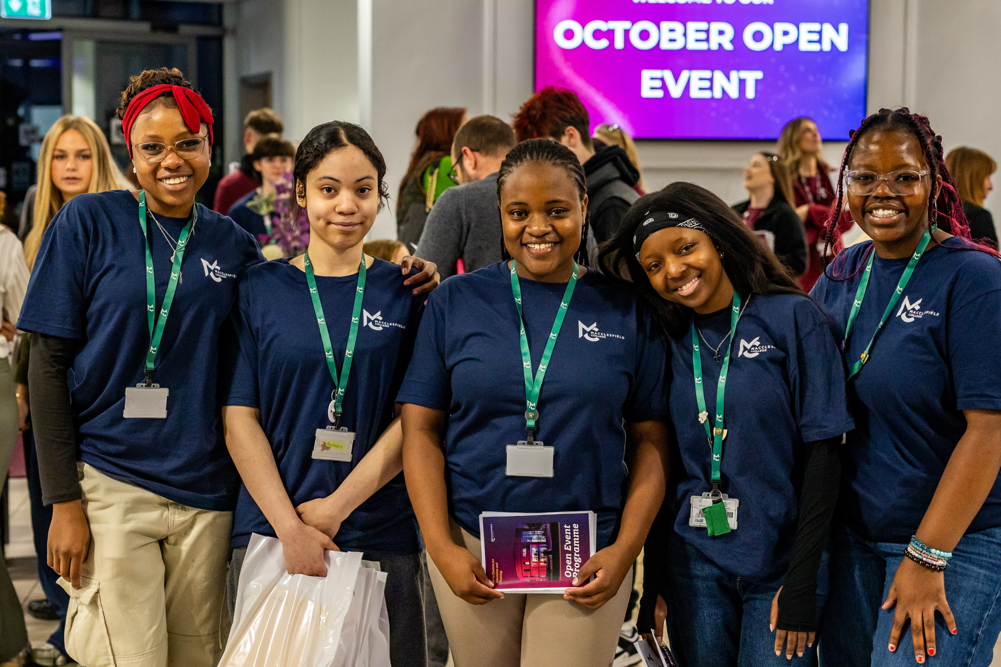 A group of student ambassadors are smiling for a photo during an open event at Macclesfield College