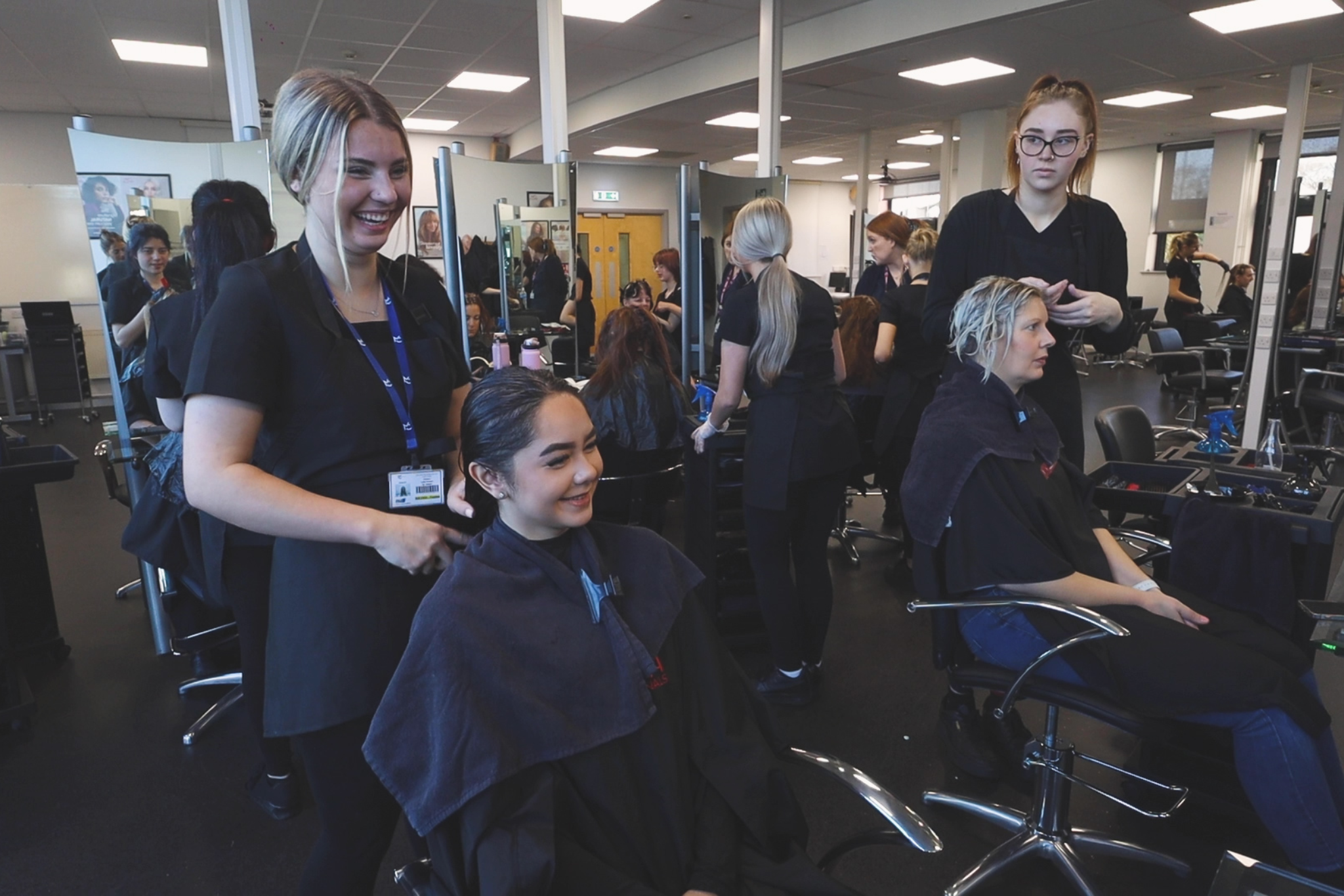 A group of hairdressing students are working in Pure Salon.