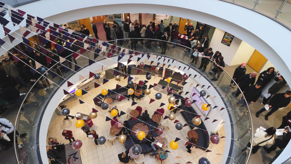 People are gathered inside Macclesfield College during an apprenticeship open event