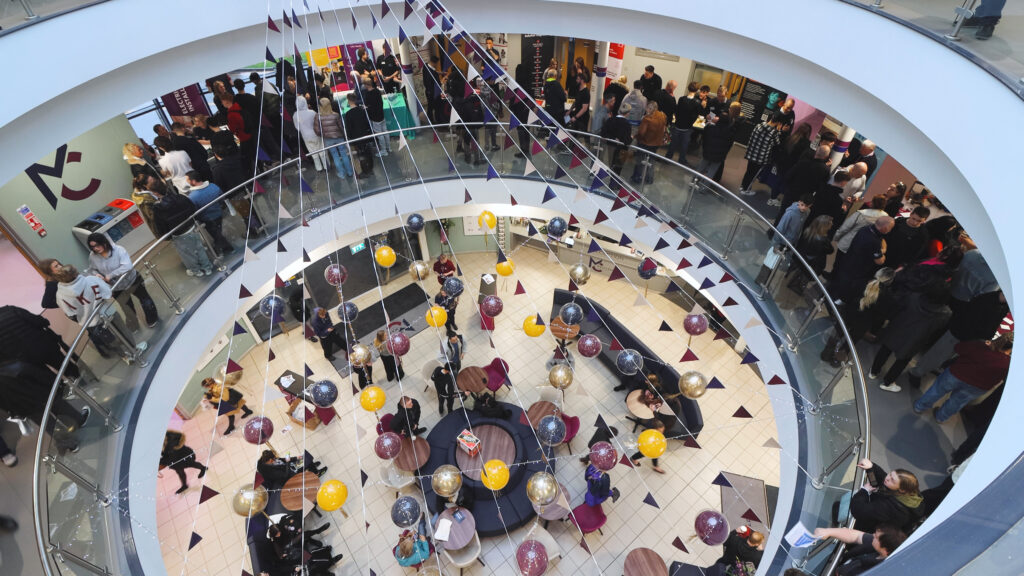 People are gathered inside Macclesfield College during an apprenticeship open event