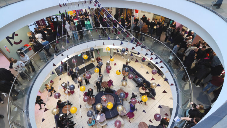 People are gathered inside Macclesfield College during an apprenticeship open event