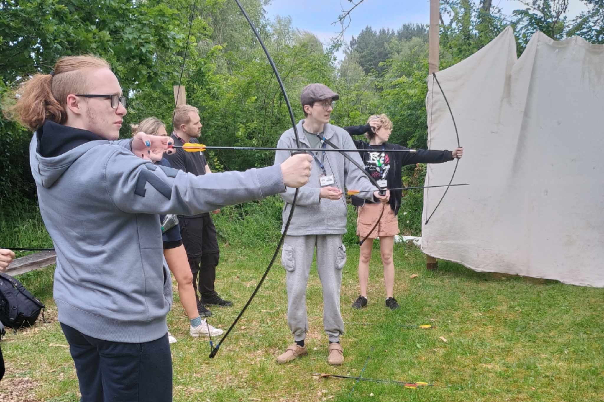 A group of Pathways students are practicing archery during a trip to Tittesworth Reservoir