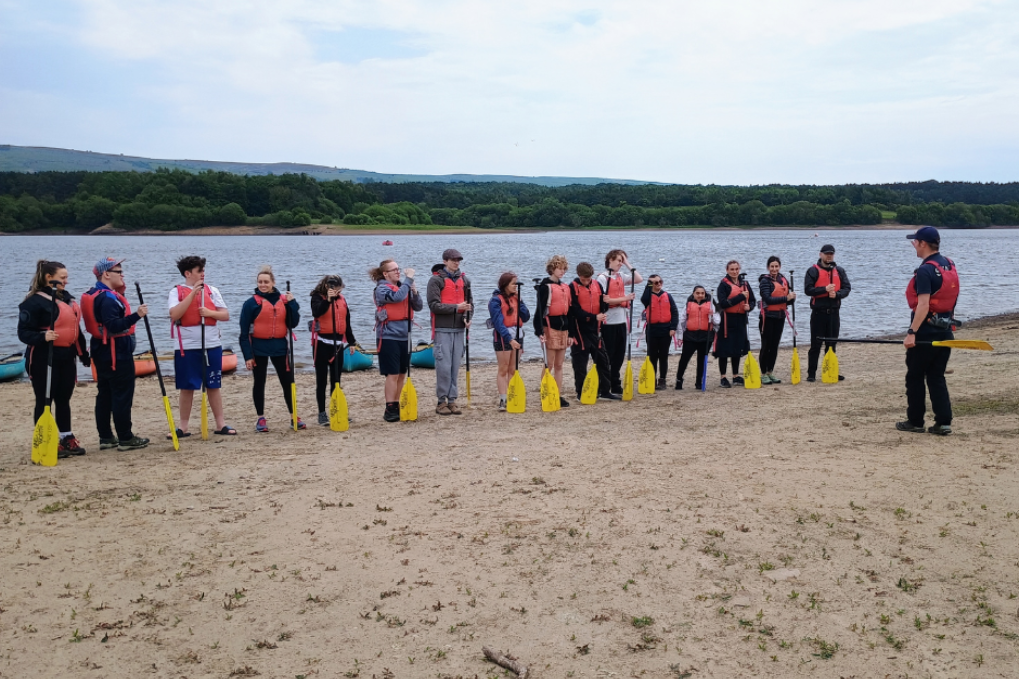 A group of Pathways students are listening to a kayak instructor during a trip to Tittesworth Reservoir.