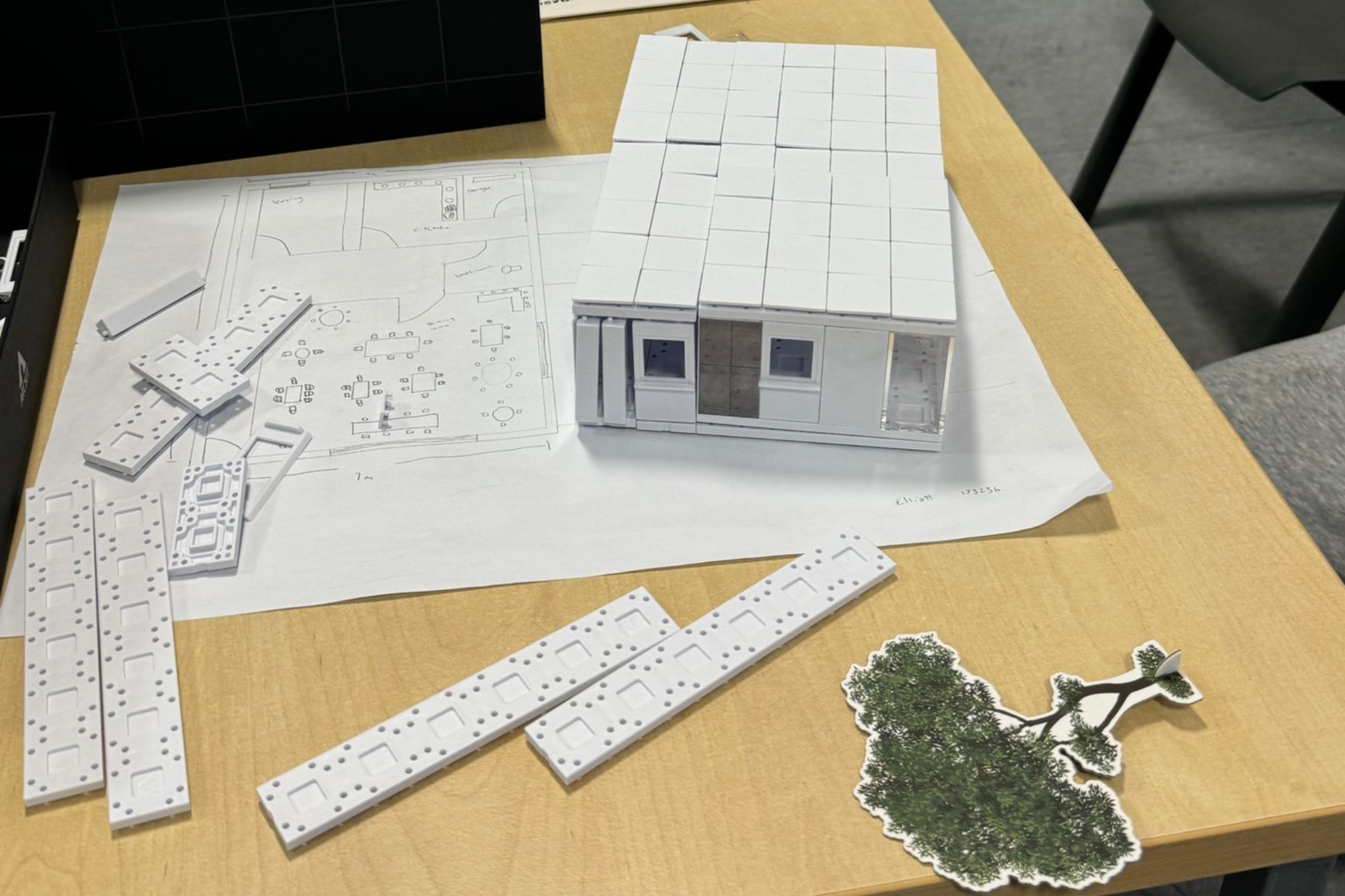 A lego house, under the house there is a construction drawing map.