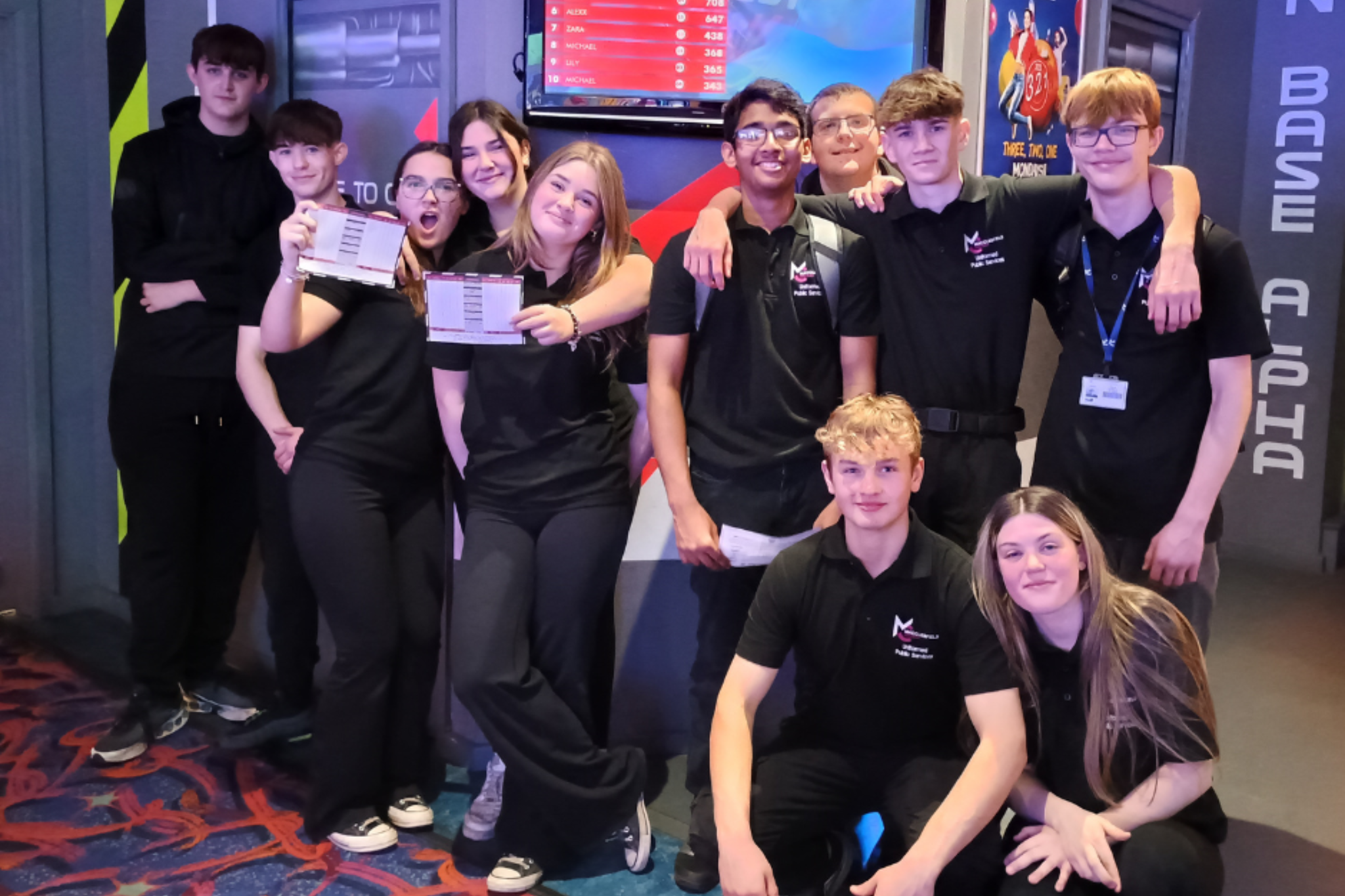 A group of Public Service students are smiling for a photo during their bowling trip.