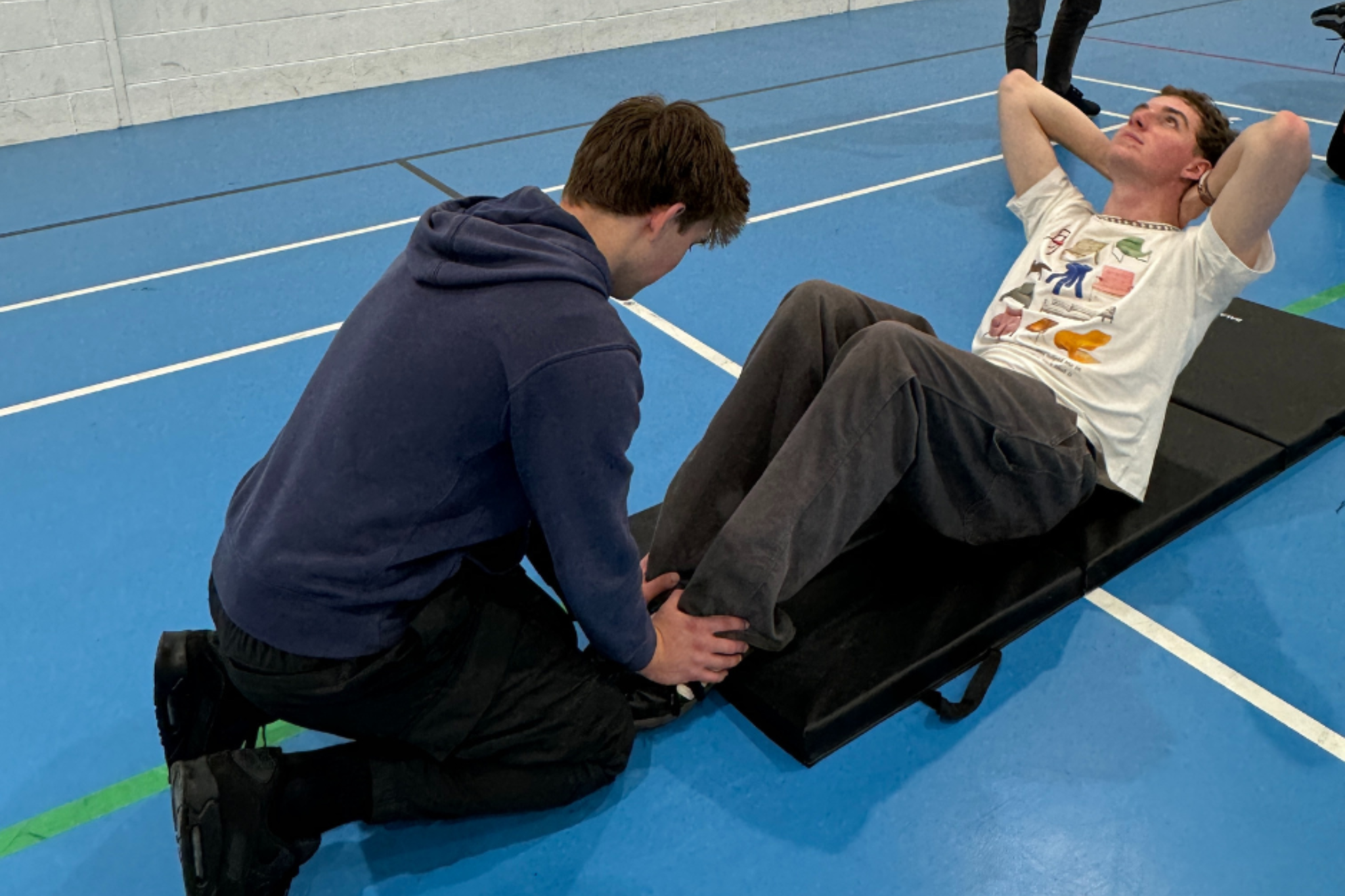Two sport students are practicing fitness techniques.