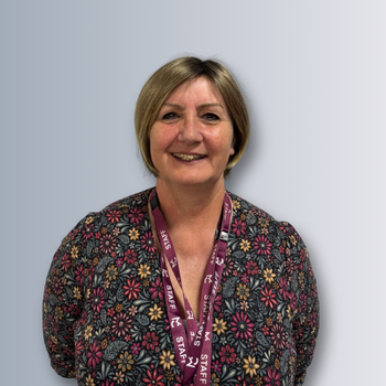 a female staff member is smiling for a headshot photo