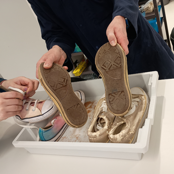 a student is holding footprint casting