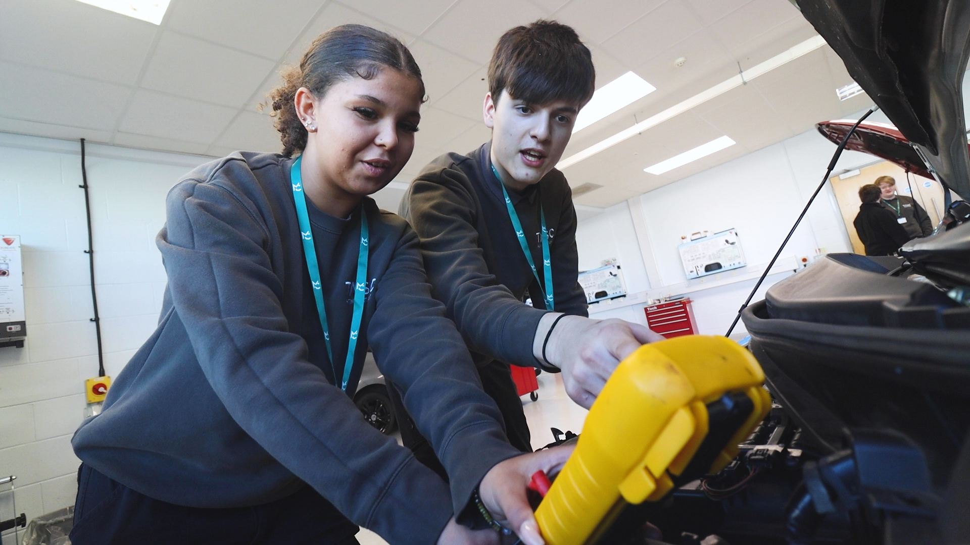two students working in a garage