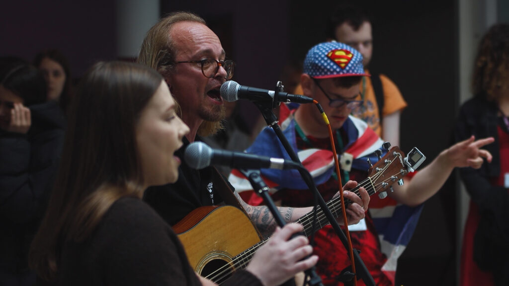 a group of people are singing
