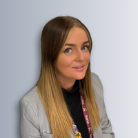 A headshot photo of a female staff member smiling