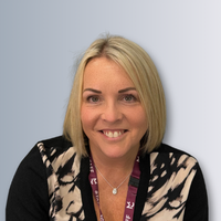 a headshot photo of a female staff member smiling