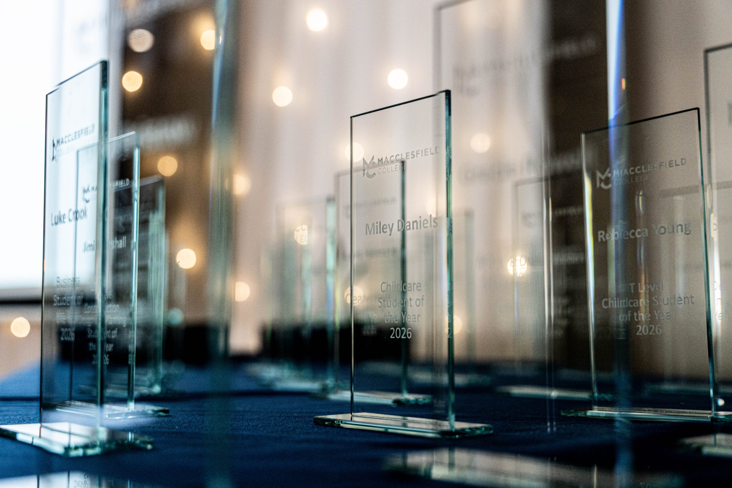 Glass awards are placed neatly on a table