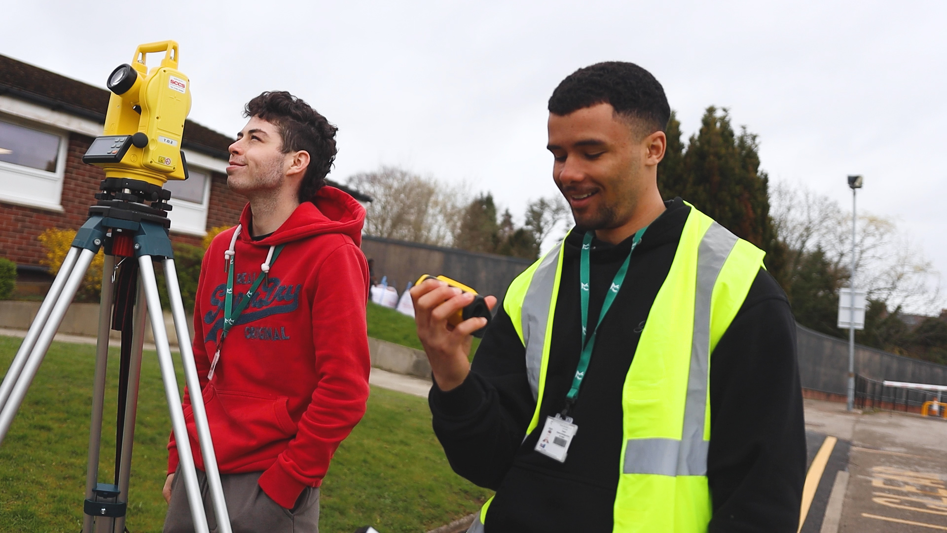 Two students are using surveying equipment