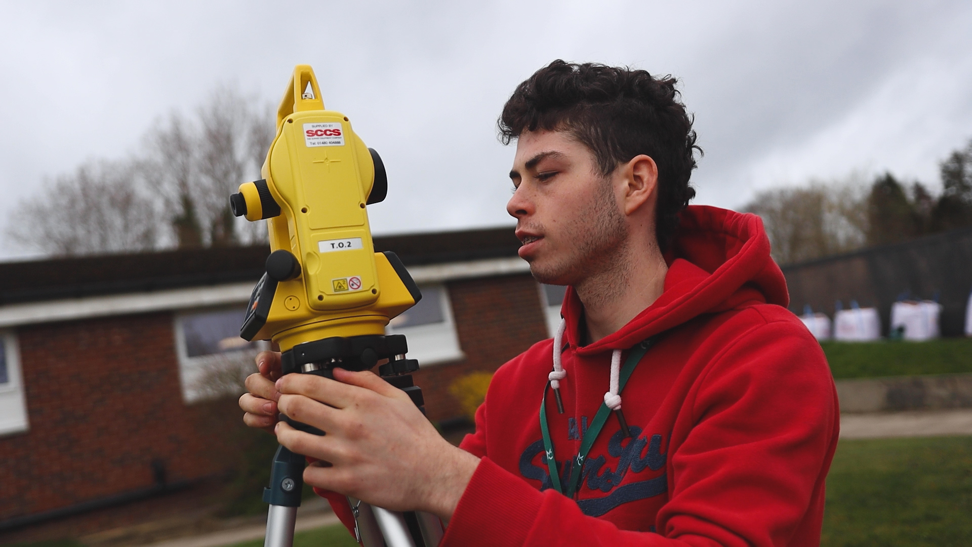 a student is using surveying equipment